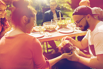 Image showing happy friends having dinner at summer garden party