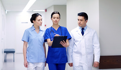 Image showing group of medics at hospital with clipboard