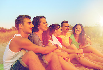 Image showing smiling friends in sunglasses on summer beach