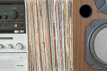 Image showing Retro receiver, amplifier stack of vinyl records near the sound speaker