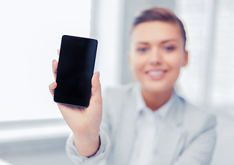 Image showing businesswoman with smartphone in office