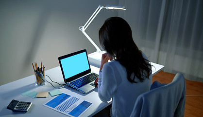 Image showing businesswoman with laptop at night office