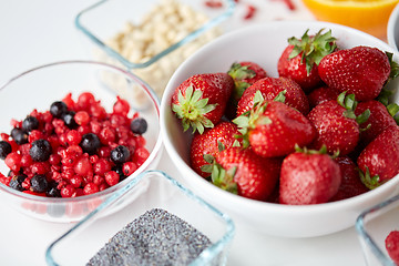 Image showing fruits and berries in bowls on table