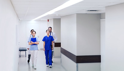 Image showing group of medics or doctors walking along hospital