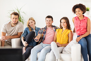 Image showing happy friends with remote watching tv at home