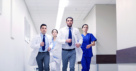 Image showing group of medics walking along hospital
