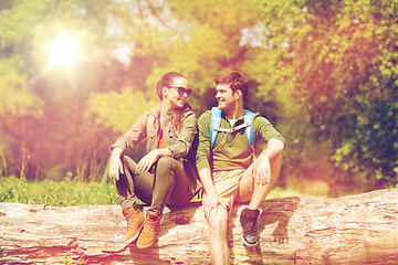 Image showing smiling couple with backpacks in nature