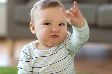 Image showing baby boy showing rock hand sign at home