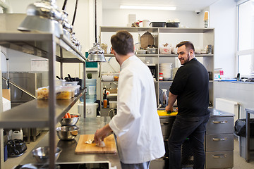 Image showing chef and cook cooking food at restaurant kitchen