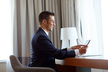 Image showing businessman with tablet pc working at hotel room