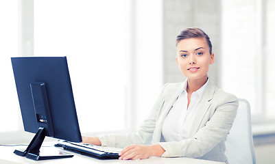 Image showing businesswoman with computer in office