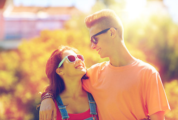 Image showing happy teenage couple looking at each other in park