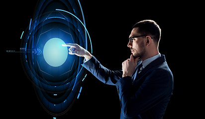 Image showing businessman with virtual projection over black