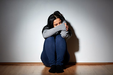 Image showing unhappy woman crying on floor at home