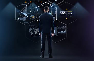 Image showing businessman looking at virtual screen from back