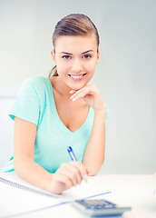 Image showing student girl with notebook and calculator