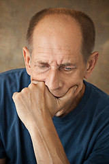 Image showing Worried mature man touching his head.