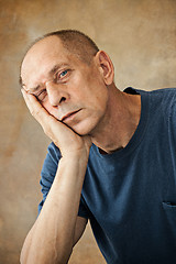 Image showing Worried mature man touching his head.