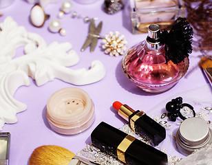 Image showing Jewelry table with lot of girl stuff on it, little mess in cosmetic brushes, women interior concept, perfume elegance things, little princess makeup