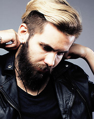 Image showing portrait of young bearded hipster guy on gray dark background close up, brutal modern man, lifestyle people concept 