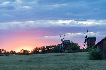 Image showing Old windmills by sunset