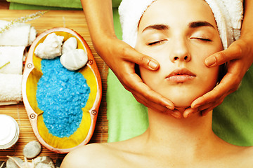 Image showing stock photo attractive lady getting spa treatment in salon, close up asian hands on face