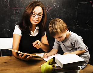 Image showing little cute boy with teacher in classroom