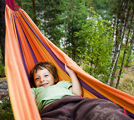 Image showing little cute boy in hammock smiling