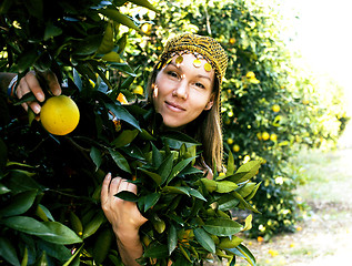 Image showing pretty islam woman in orange grove smiling