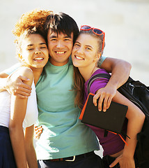 Image showing cute group of teenages at the building of university with books huggings, back to school