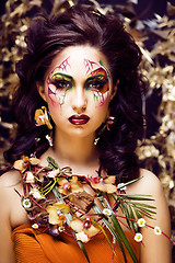 Image showing beauty woman with face art and jewelry from flowers orchids