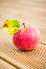 Image showing Ripe red apple with a leaf, close-up