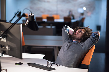 Image showing businessman relaxing at the desk