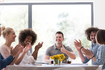 Image showing multiethnic startup Group of young business people celebrating s