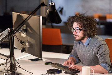 Image showing man working on computer in dark startup office