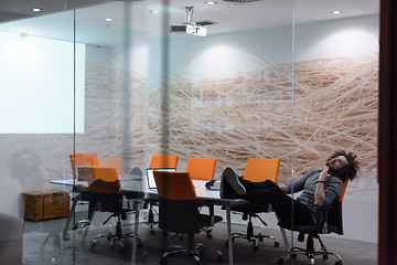 Image showing businessman relaxing at the desk