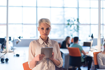 Image showing woman working on digital tablet in night office