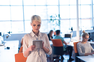 Image showing woman working on digital tablet in night office