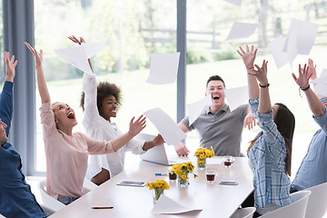 Image showing multiethnic startup Group of young business people throwing docu