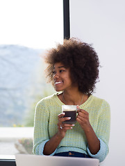 Image showing black woman in the living room on the floor