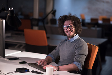 Image showing man working on computer in dark startup office