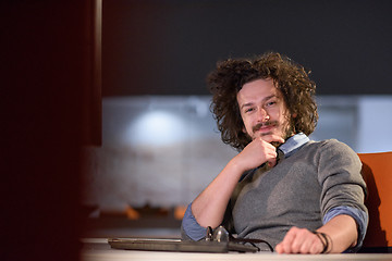 Image showing man working on computer in dark startup office