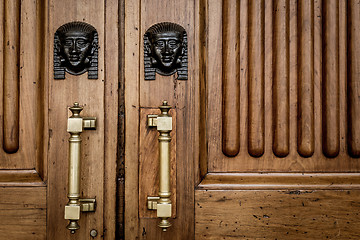 Image showing Sphinx heads entrance on wooden door