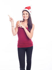 Image showing Happy christmas woman pointing