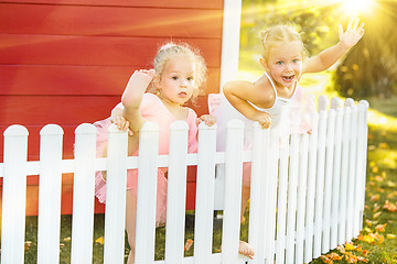 Image showing The two little girls at playground against park or green forest