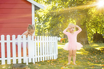 Image showing The two little girls at playground against park or green forest