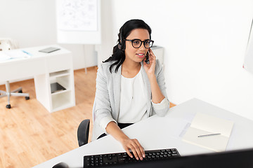 Image showing businesswoman with headset and computer at office