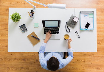 Image showing businesswoman with laptop and coffee at office