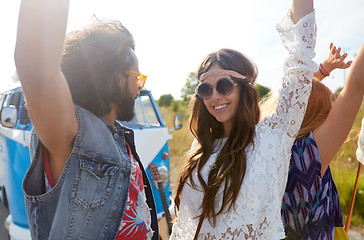 Image showing smiling hippie friends having fun near minivan car