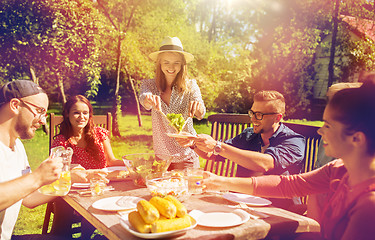 Image showing happy friends having dinner at summer garden party